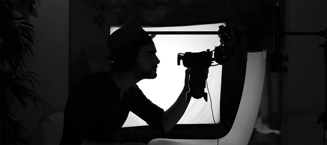 Pedro Ribeiro silhouetted behind his camera.
